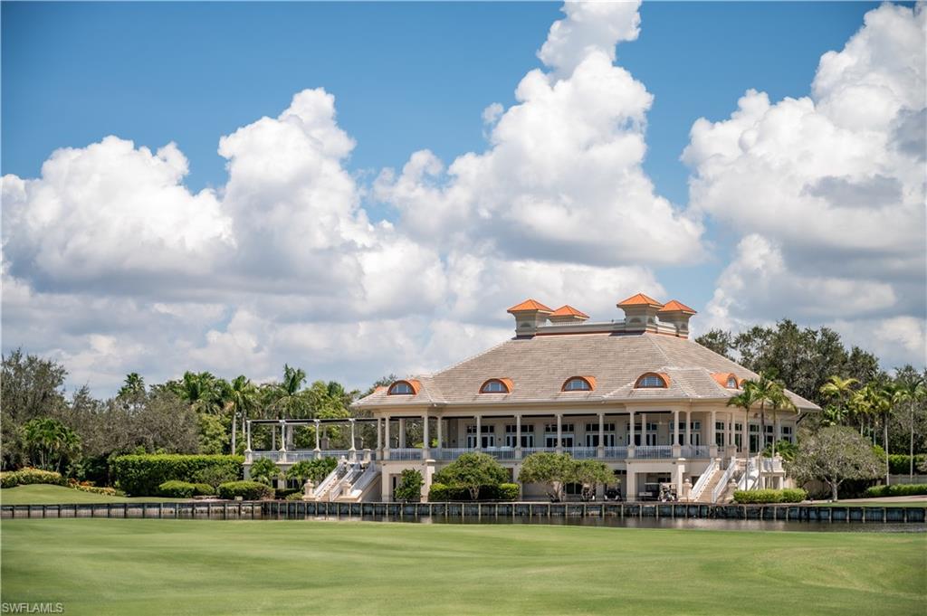 2087 Rivoli Court Naples, FL 34105 - Photo 30 of 37 a view of a large white building with a big yard and large trees