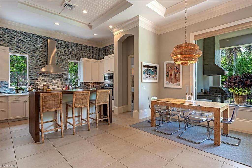2087 Rivoli Court Naples, FL 34105 - Photo 5 of 37 a dining hall with stainless steel appliances granite countertop a table and chairs