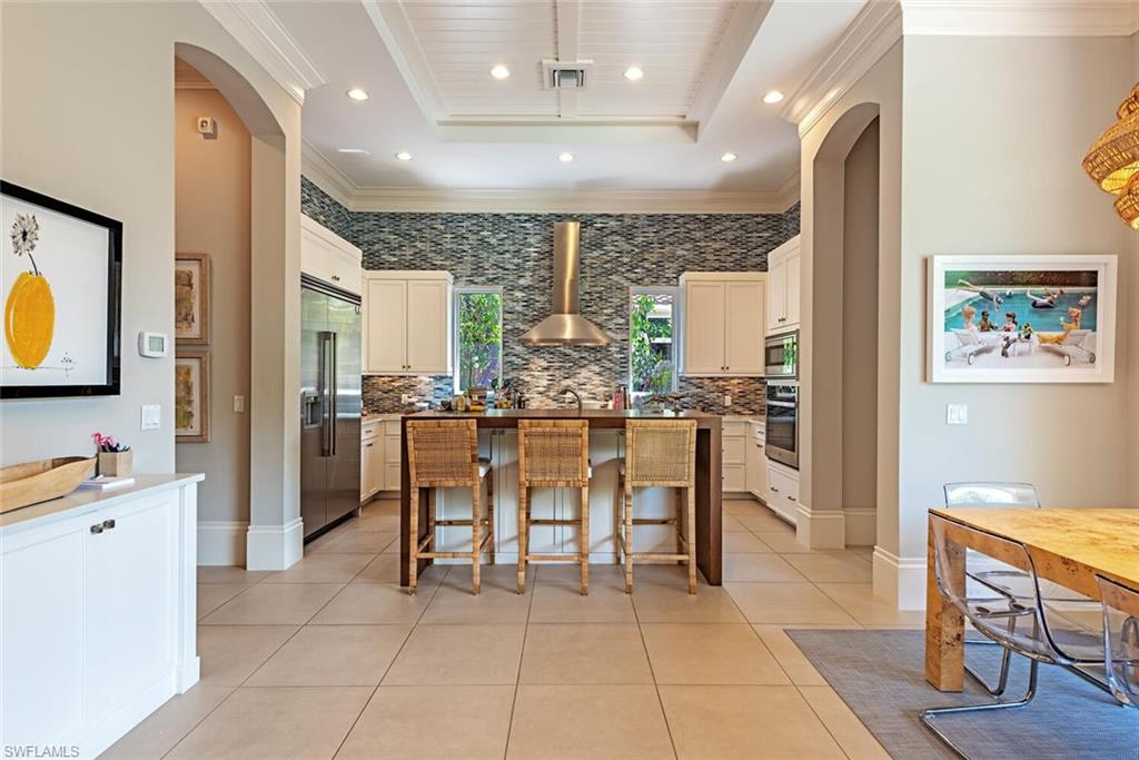 2087 Rivoli Court Naples, FL 34105 - Photo 6 of 37 a room with dining table and chairs