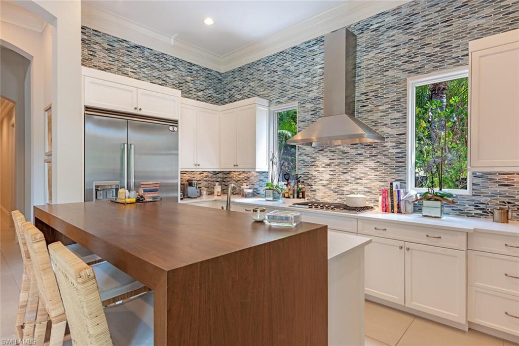 2087 Rivoli Court Naples, FL 34105 - Photo 7 of 37 a kitchen with a sink dishwasher and cabinets with wooden floor