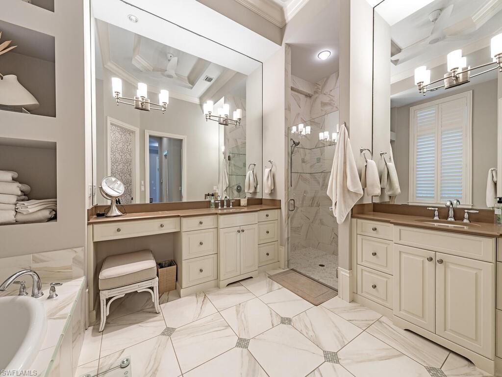 2087 Rivoli Court Naples, FL 34105 - Photo 9 of 37 a spacious bathroom with a granite countertop sink a toilet a mirror and shower