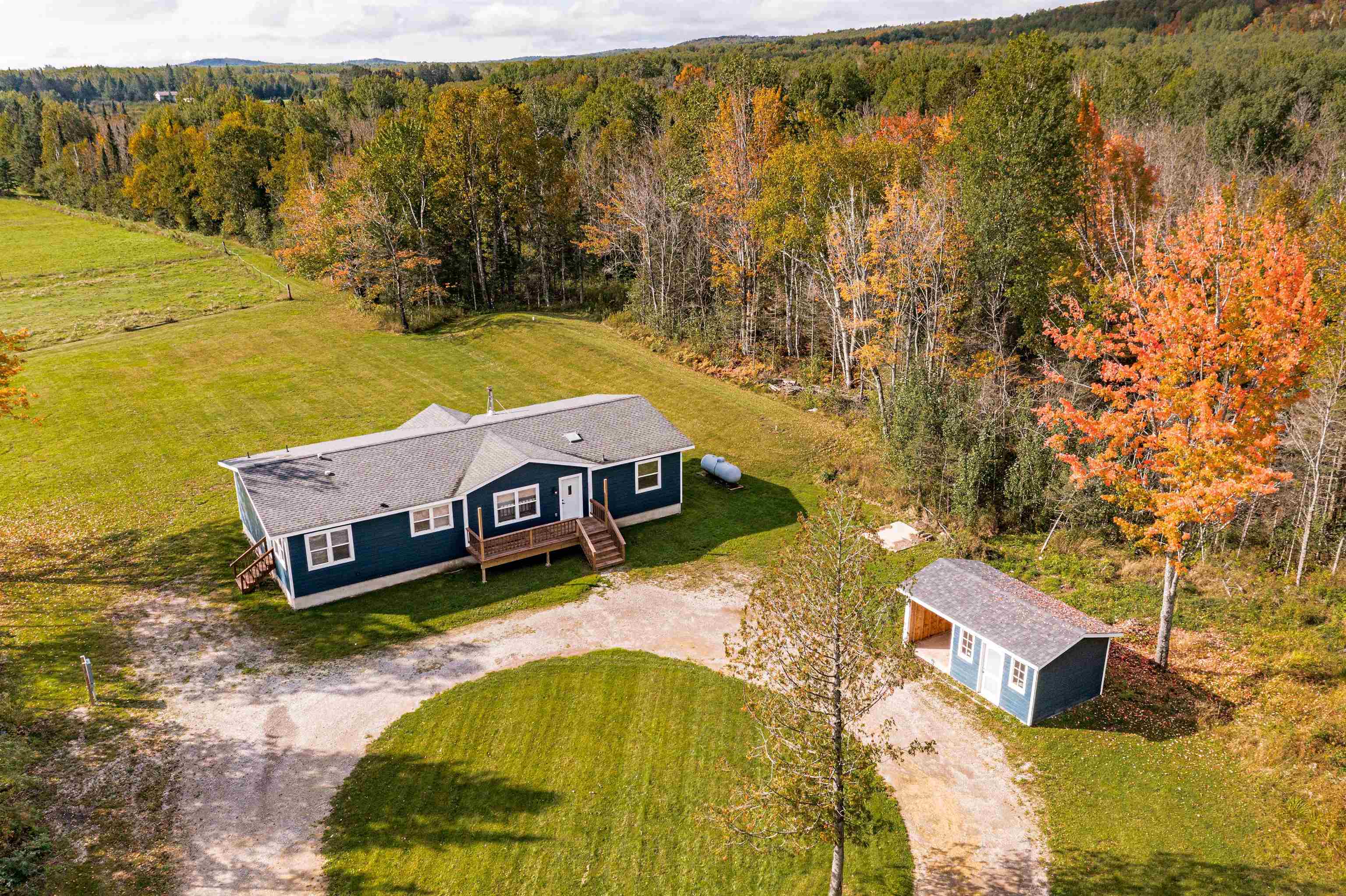 View of subject property with a heavily wooded area & also open area.