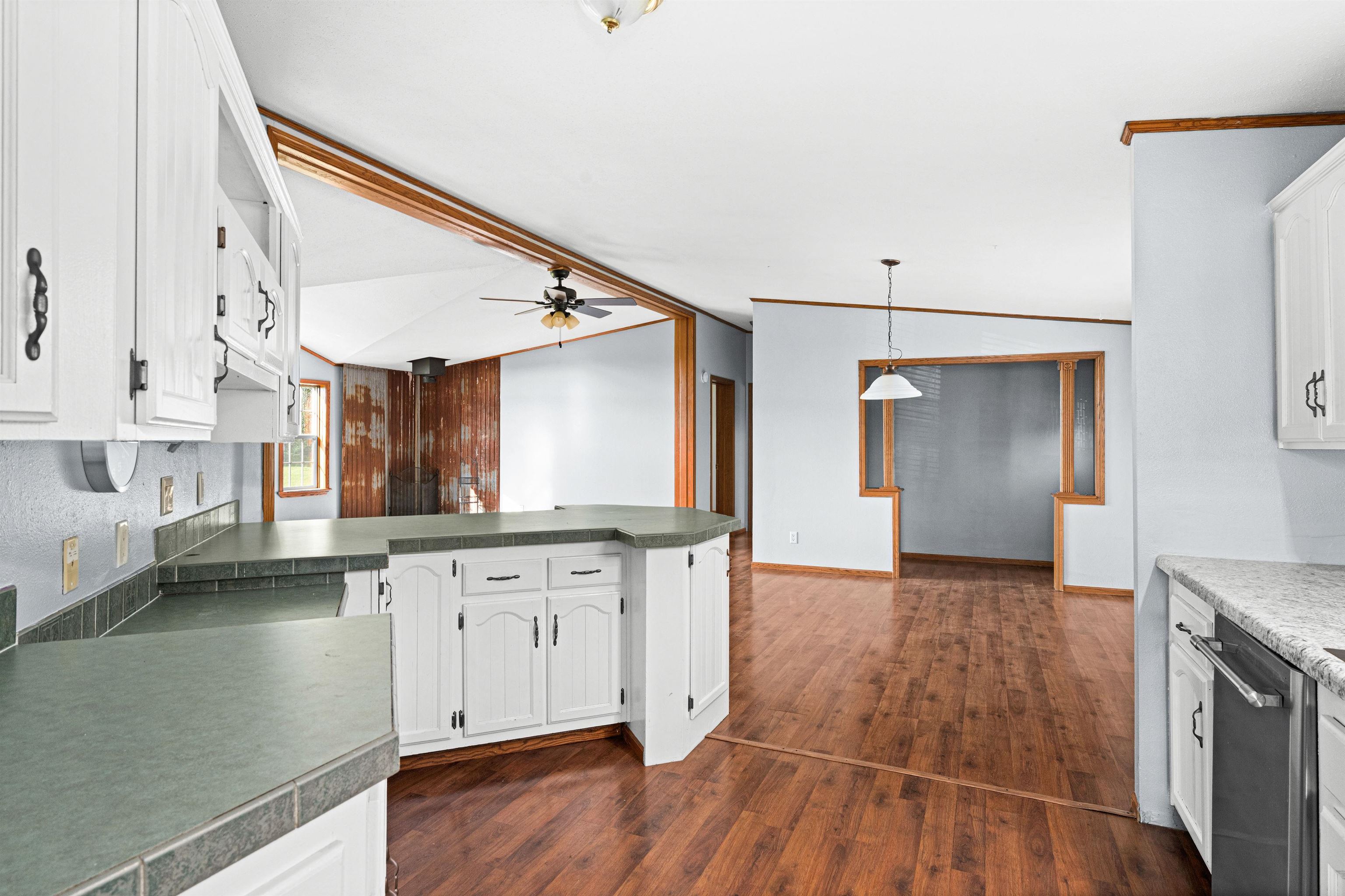 3126 Beyer Road Duluth, MN 55804 - Photo 7 of 22 Kitchen with white cabinets, laminate flooring, & a peninsula.