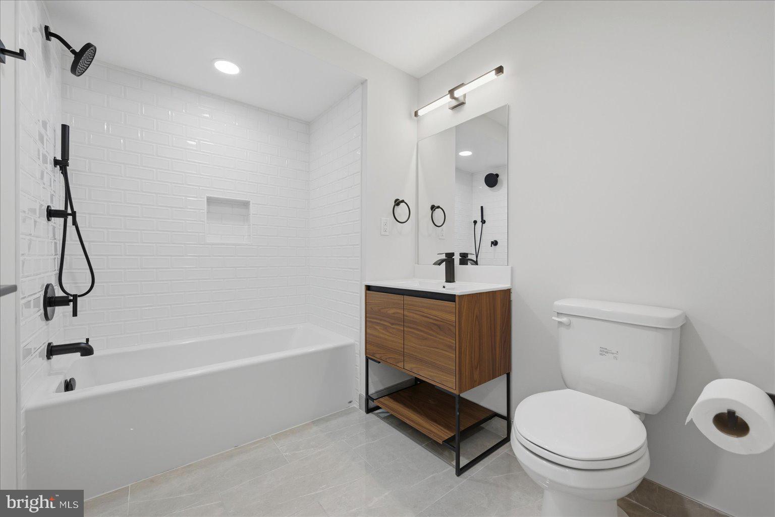 919 12th Street Northeast, Unit 303 Washington, DC 20002 - Photo 13 of 22 a bathroom with a sink toilet and shower