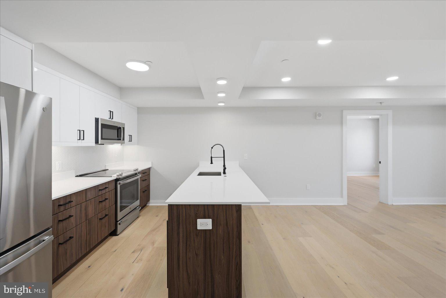 919 12th Street Northeast, Unit 303 Washington, DC 20002 - Photo 2 of 22 a kitchen with stainless steel appliances granite countertop a refrigerator a sink and a stove