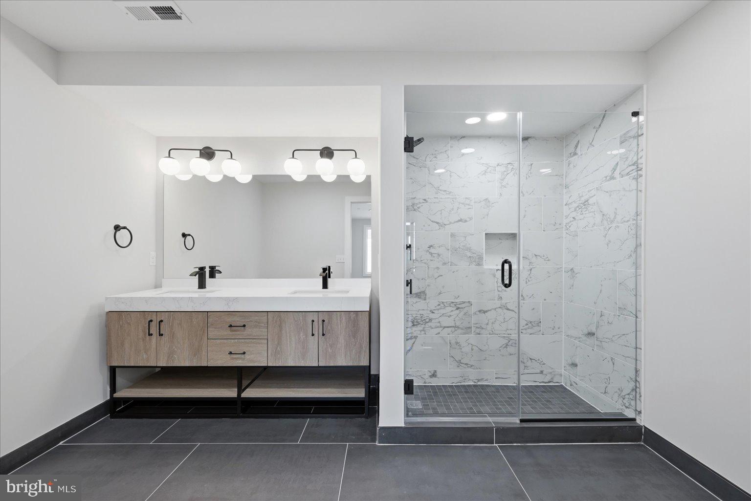 919 12th Street Northeast, Unit 303 Washington, DC 20002 - Photo 10 of 22 a bathroom with a mirror and a shower
