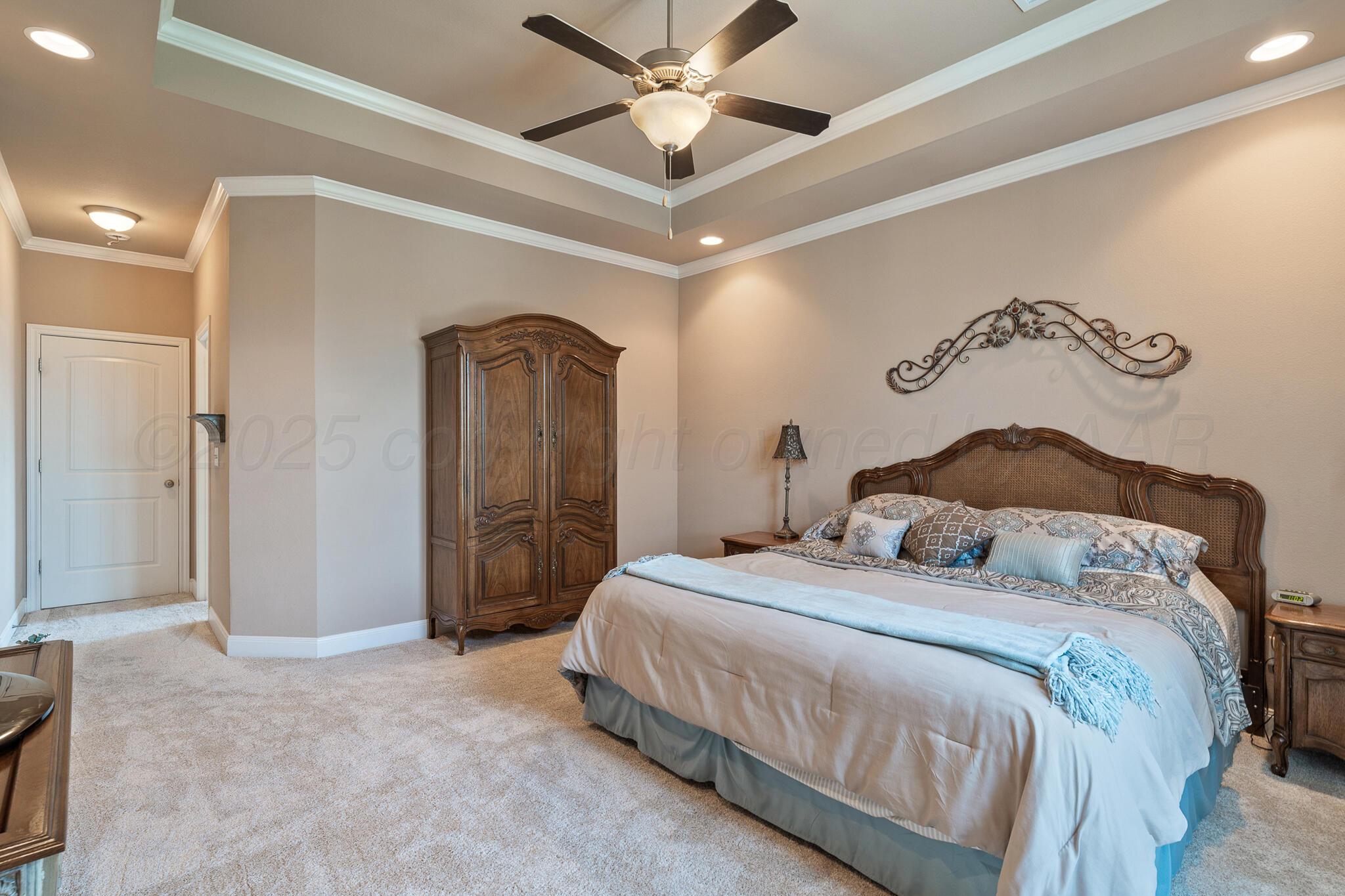 7116 Sinclair Street Amarillo, TX 79119 - Photo 13 of 23 a bedroom with a bed and a chandelier