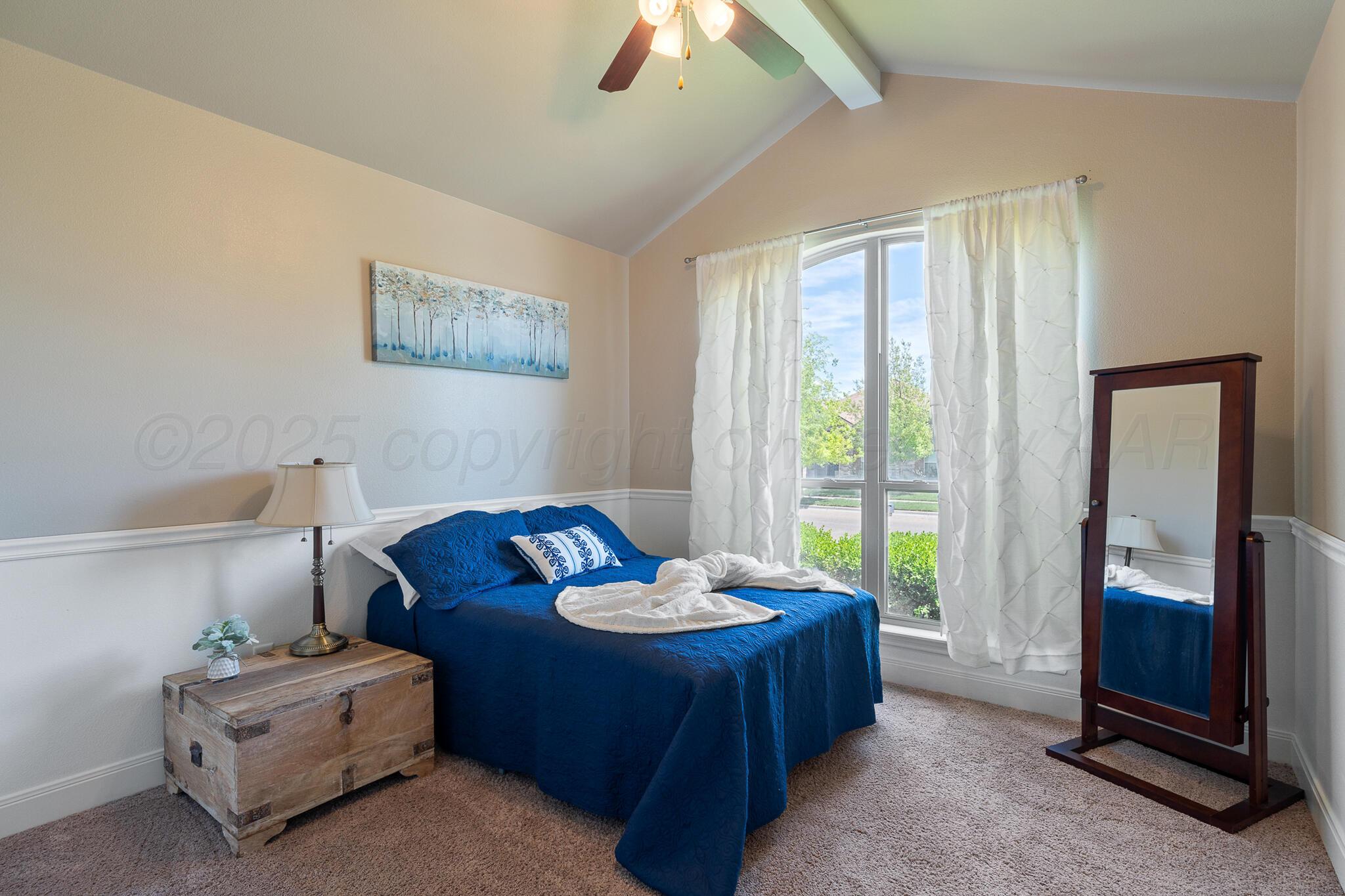 7116 Sinclair Street Amarillo, TX 79119 - Photo 18 of 23 a bed room with a bed and a chandelier