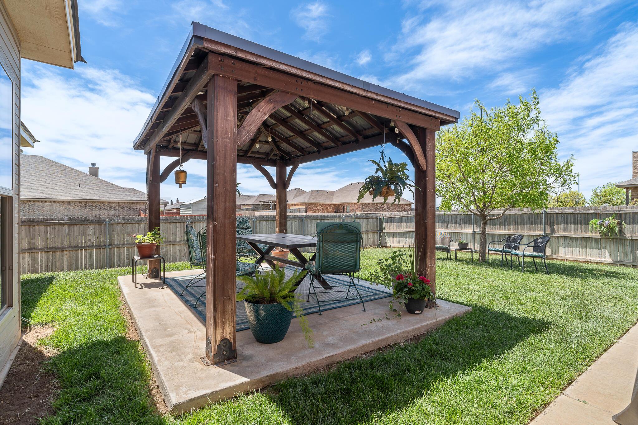 7116 Sinclair Street Amarillo, TX 79119 - Photo 19 of 23 a view of a chair and table in backyard of the house