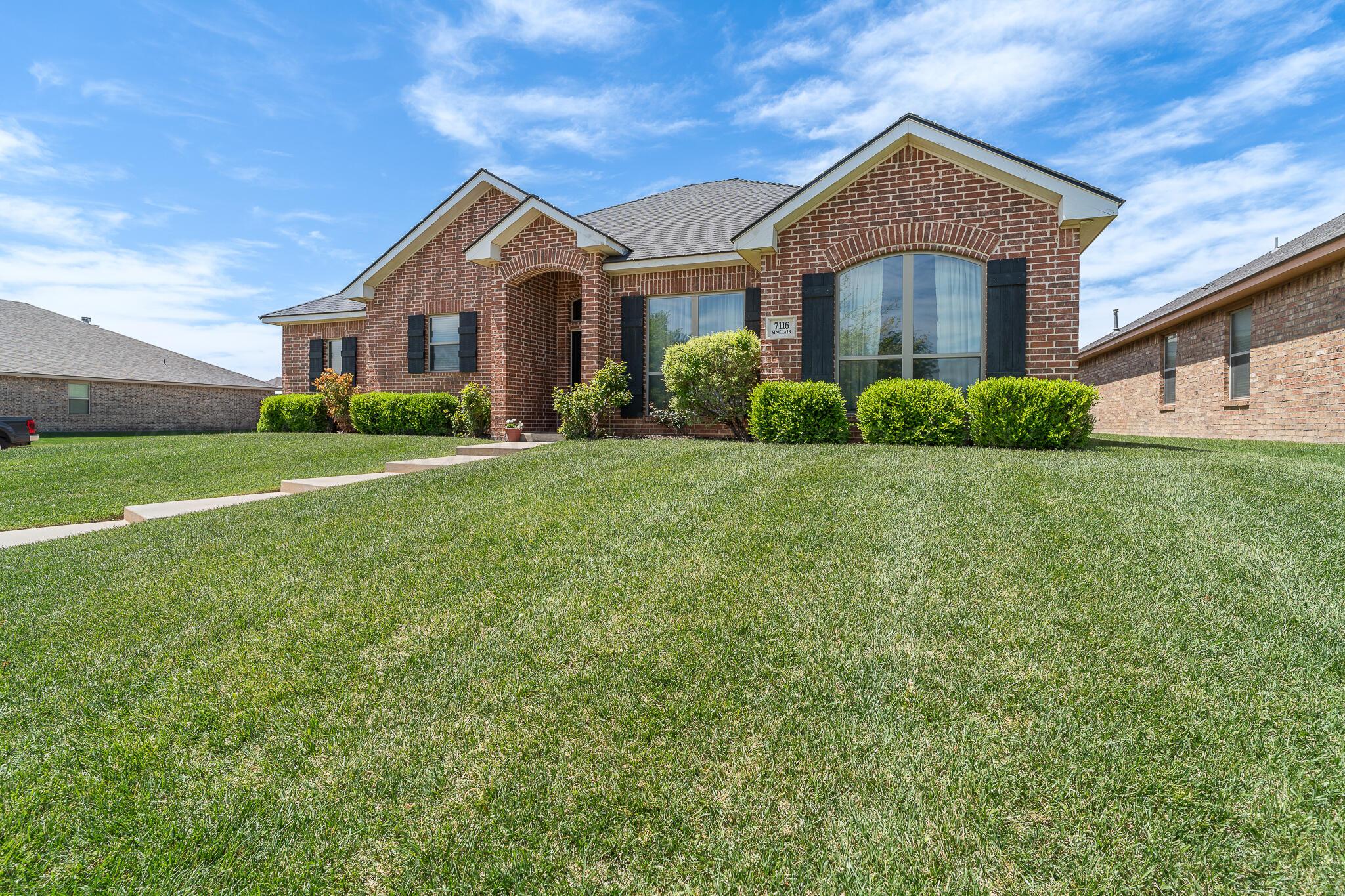 7116 Sinclair Street Amarillo, TX 79119 - Photo 2 of 23 a front view of a house with a yard