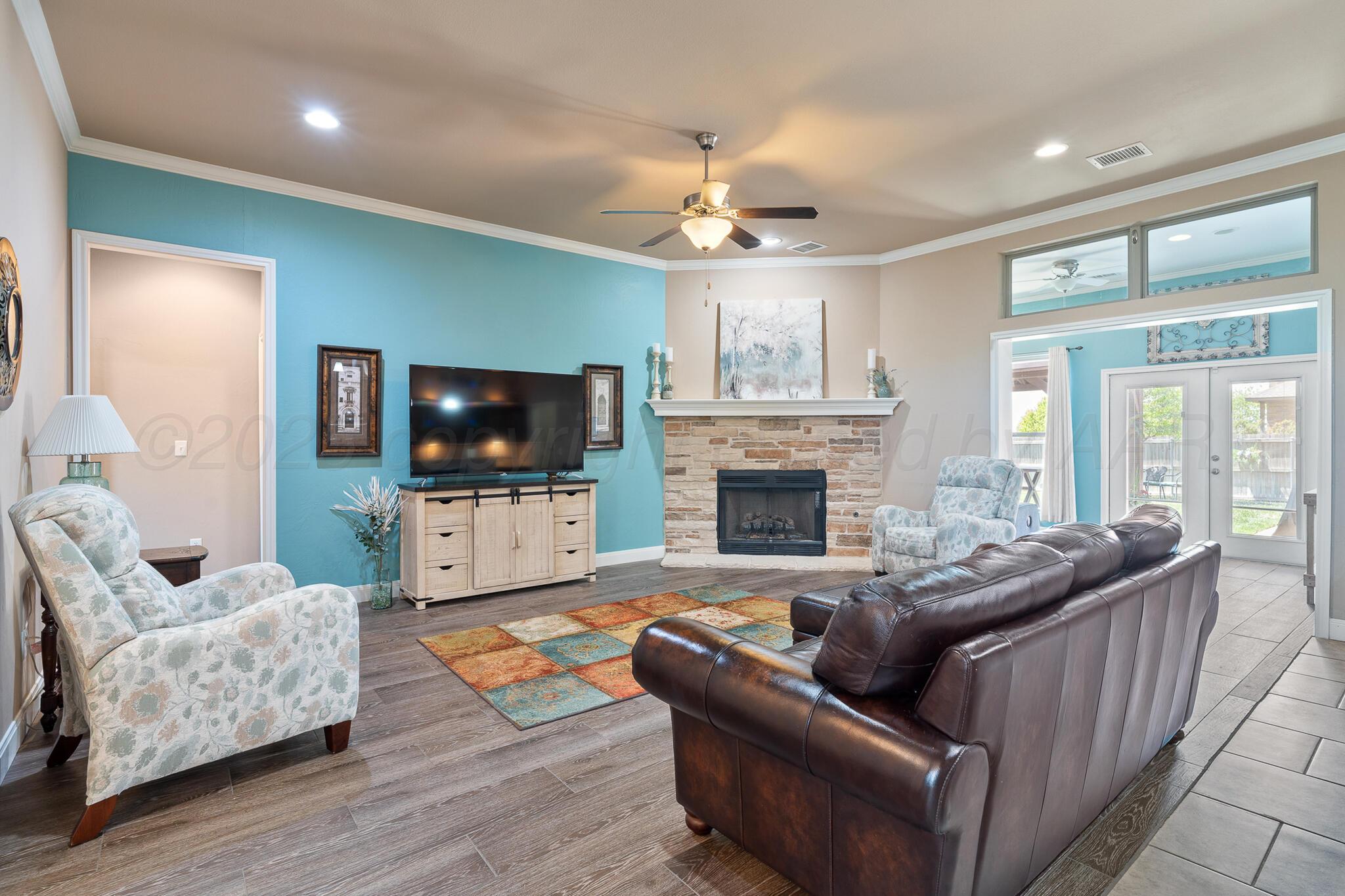 7116 Sinclair Street Amarillo, TX 79119 - Photo 3 of 23 a living room with furniture and a flat screen tv