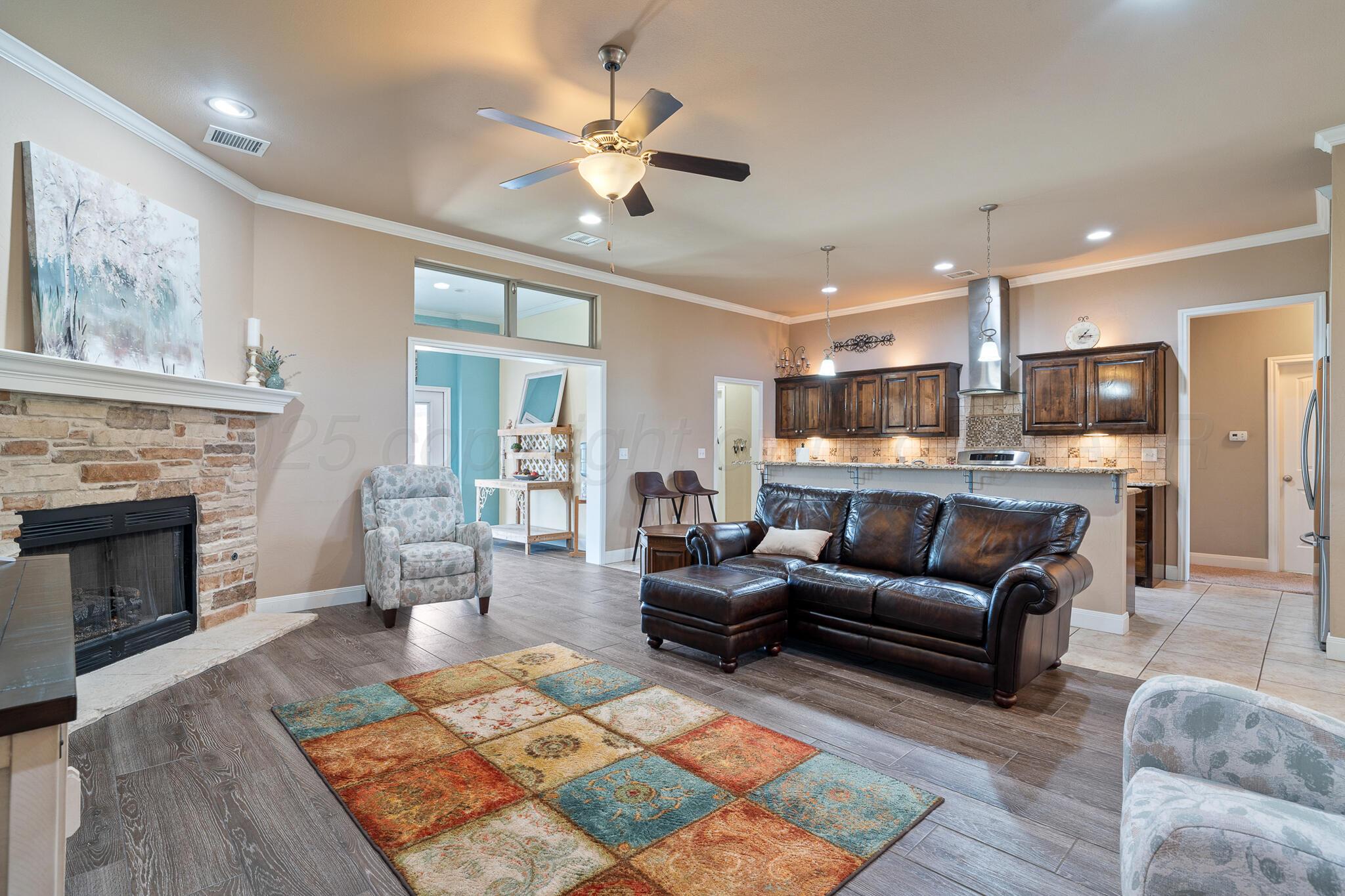 7116 Sinclair Street Amarillo, TX 79119 - Photo 4 of 23 a living room with furniture and a fireplace