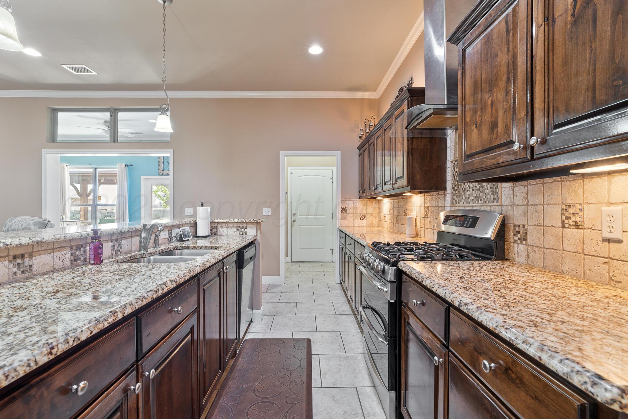 7116 Sinclair Street Amarillo, TX 79119 - Photo 6 of 23 a kitchen with granite countertop stainless steel appliances and a counter space