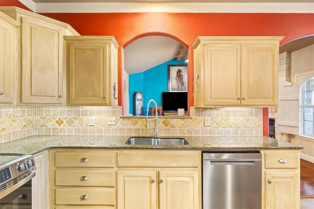 551 Bottoms East Road Temple, TX 76501 - Photo 13 of 44 a kitchen with granite countertop a sink stainless steel appliances and cabinets
