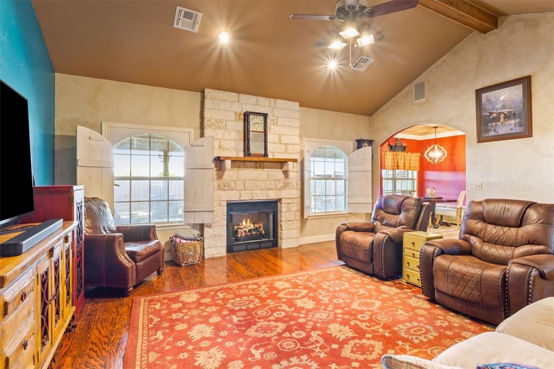 551 Bottoms East Road Temple, TX 76501 - Photo 16 of 44 a living room with furniture a fireplace and a flat screen tv