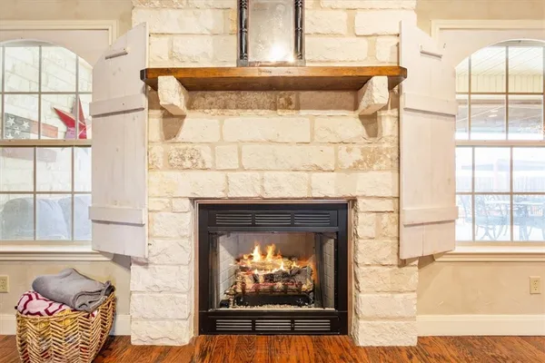 a living room with a fireplace and a large window