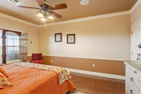 a bedroom with a bed and a chandelier