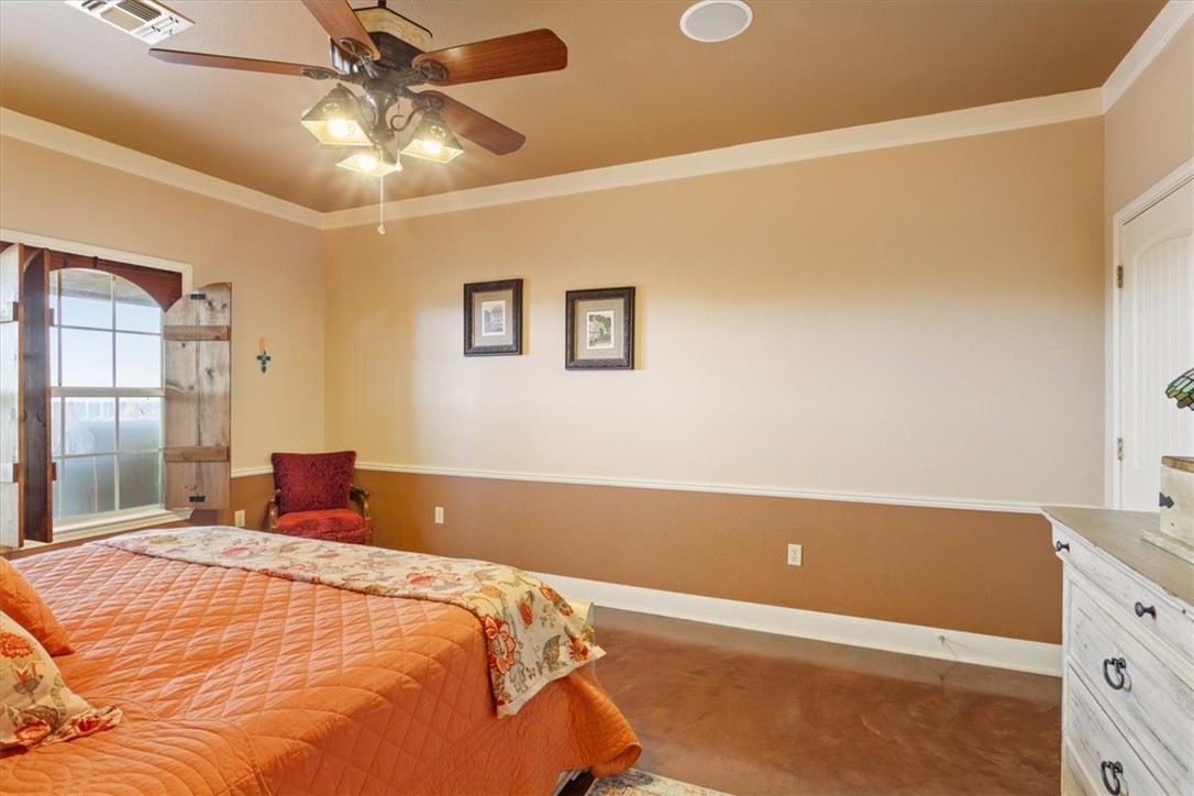 551 Bottoms East Road Temple, TX 76501 - Photo 22 of 44 a bedroom with a bed and a chandelier