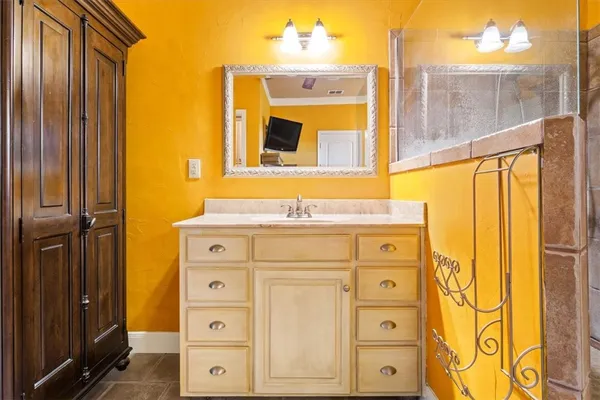 a bathroom with a granite countertop sink and a mirror