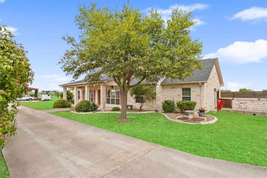 551 Bottoms East Road Temple, TX 76501 - Photo 3 of 44 a front view of a house with a garden and trees