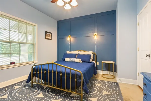 a bedroom with a bed and a window