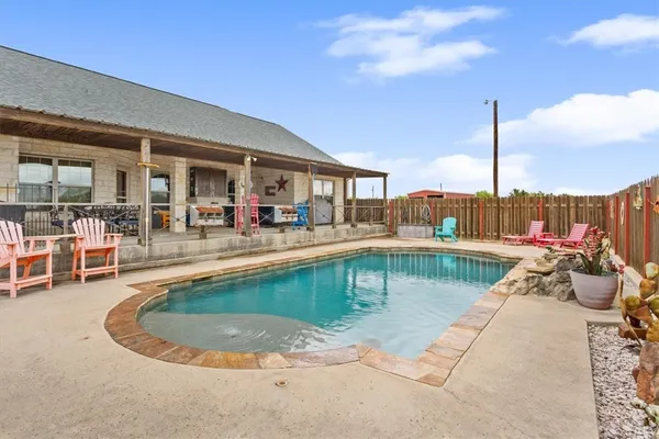 a view of a swimming pool with outdoor seating