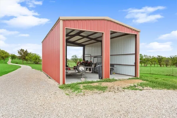 a view of backyard of house and car parked