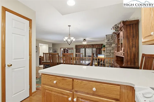 a kitchen with stainless steel appliances granite countertop white cabinets sink and window