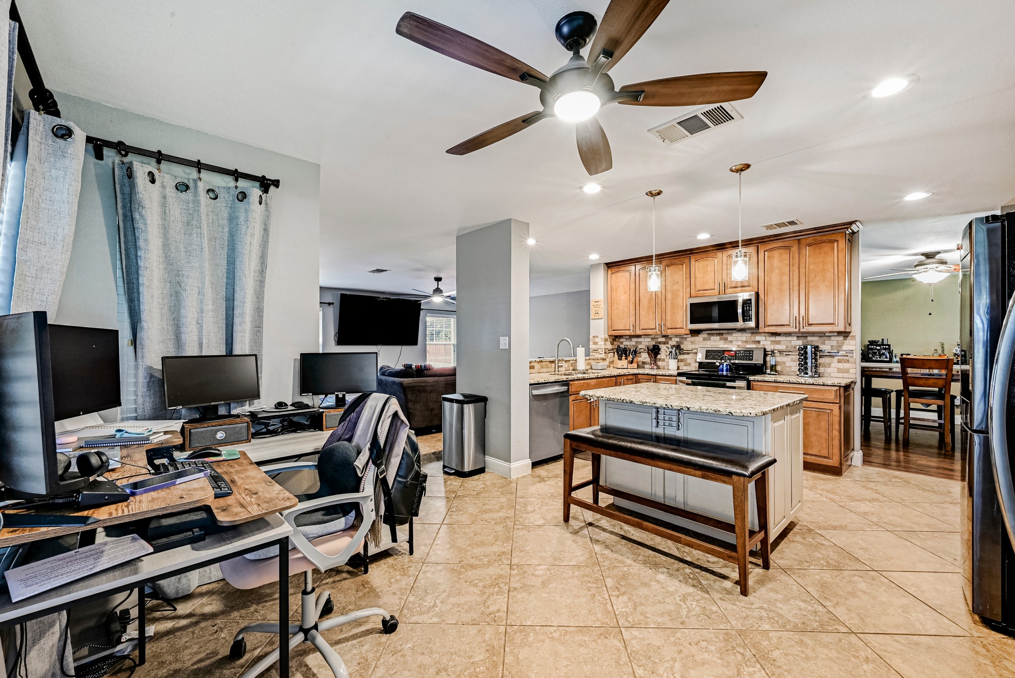 104 North Sumac Lane Georgetown, TX 78633 - Photo 19 of 40 An open-concept layout connects a functional home office space with a well-appointed kitchen, promoting productivity and seamless living.