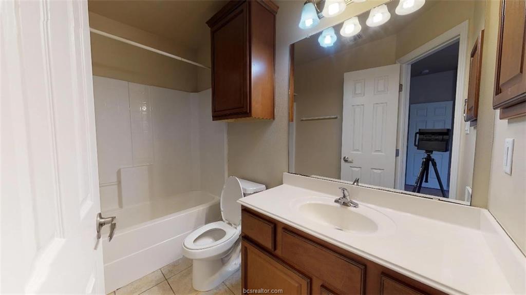 1198 Jones-Butler Road, Unit 2607 College Station, TX 77840 - Photo 13 of 20 a bathroom with a sink a toilet a mirror and shower
