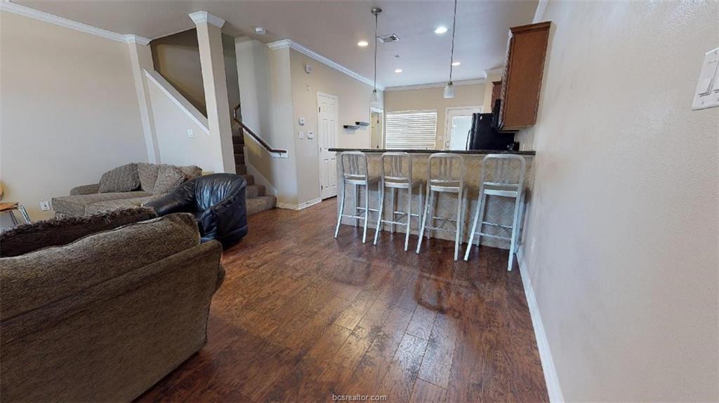 1198 Jones-Butler Road, Unit 2607 College Station, TX 77840 - Photo 2 of 20 a living room with furniture and kitchen view