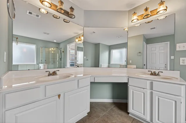 a bathroom with a sink vanity and mirror