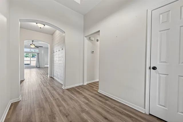 a view of a hallway with wooden floor