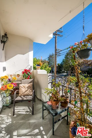 a view of a dining room with furniture and a flat screen tv