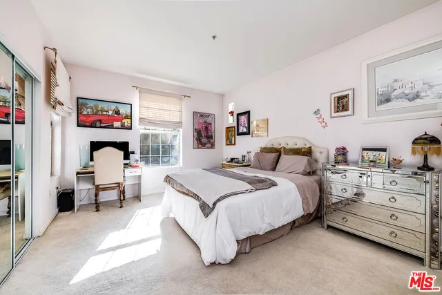 a spacious bathroom with a toilet sink and mirror