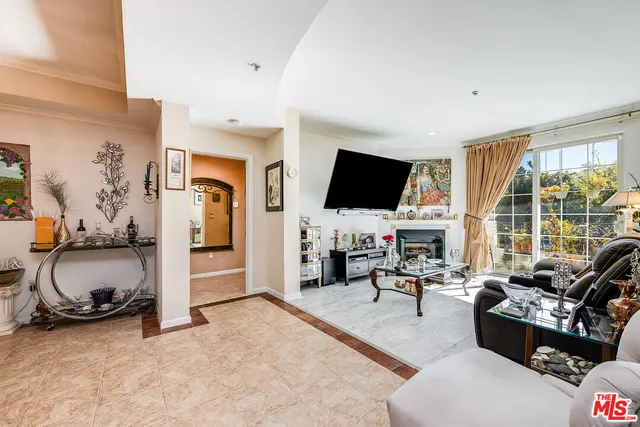 a living room with furniture fireplace and flat screen tv