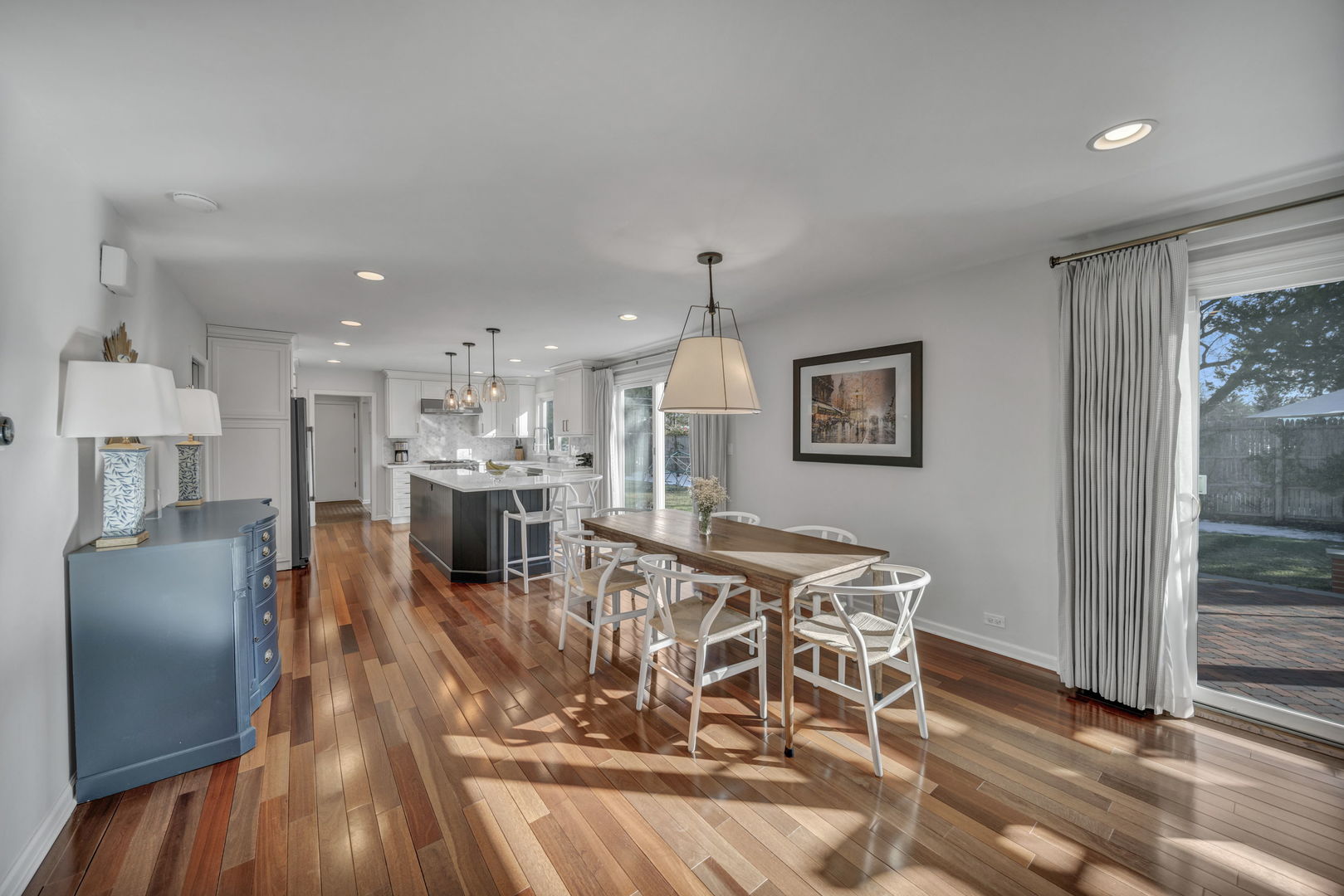 1810 Wagner Road Glenview, IL 60025 - Photo 11 of 32 a view of a dining room and livingroom with furniture wooden floor a chandelier
