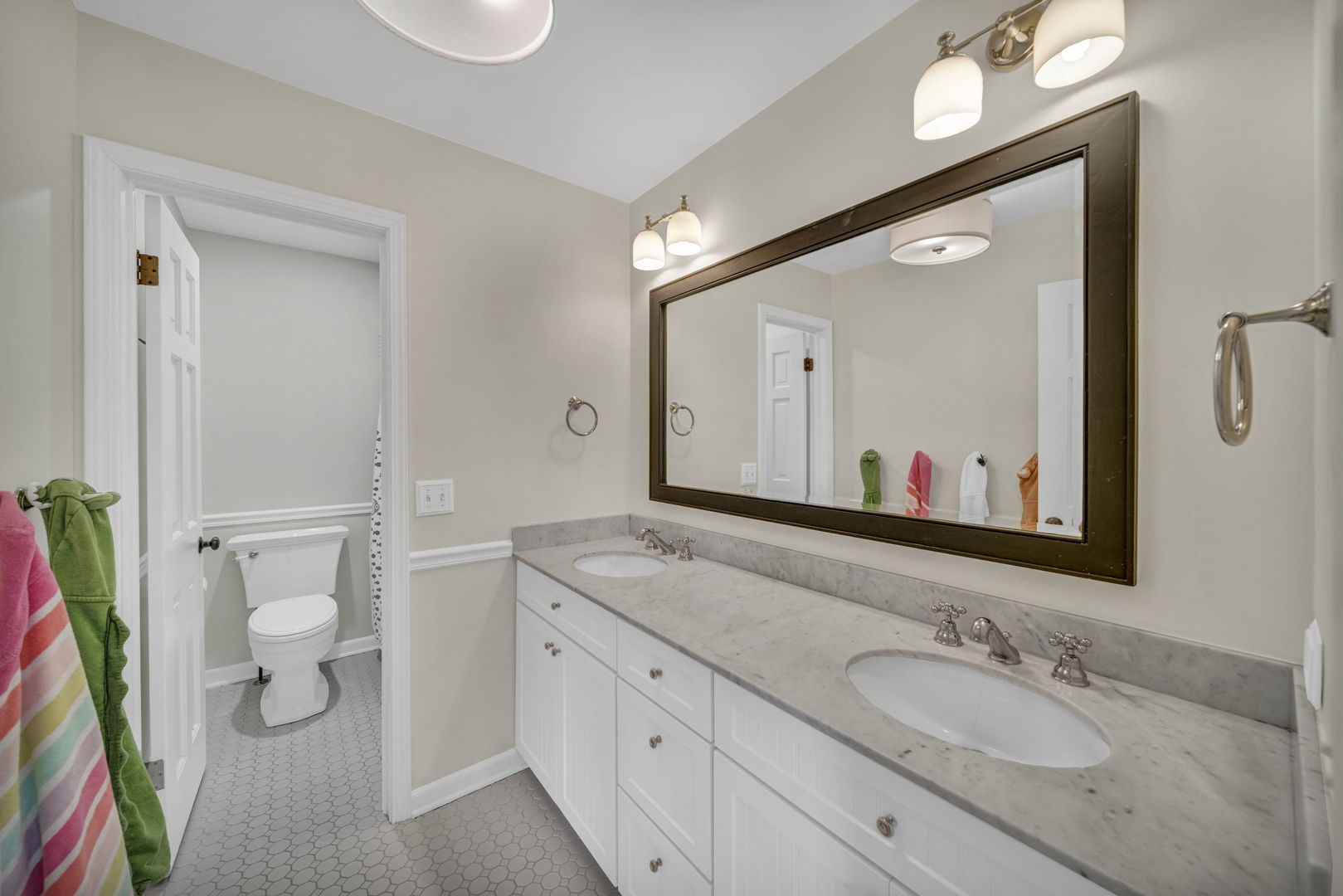1810 Wagner Road Glenview, IL 60025 - Photo 20 of 32 a bathroom with a granite countertop sink mirror vanity and toilet