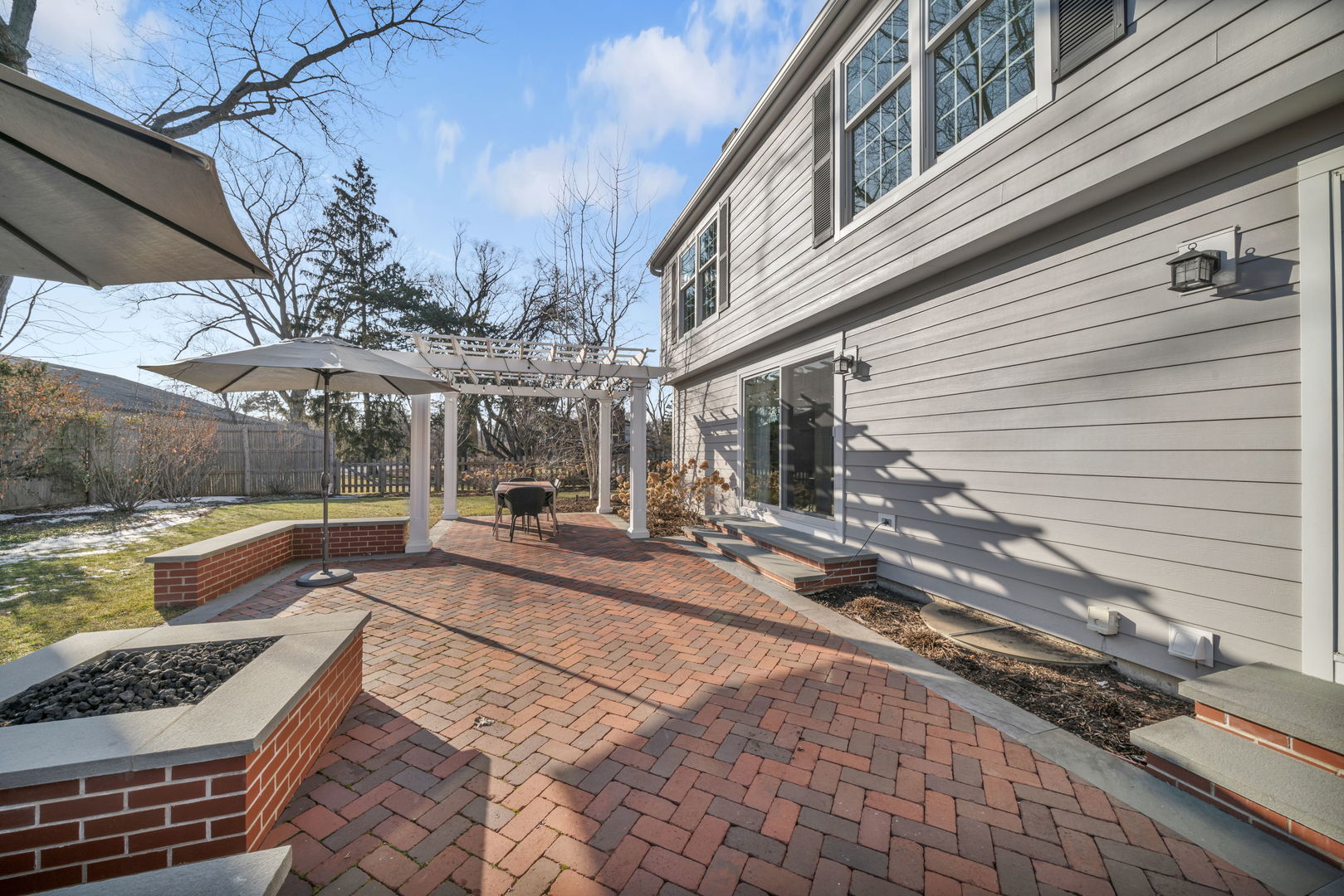 1810 Wagner Road Glenview, IL 60025 - Photo 26 of 32 a view of a patio with table and chairs under an umbrella