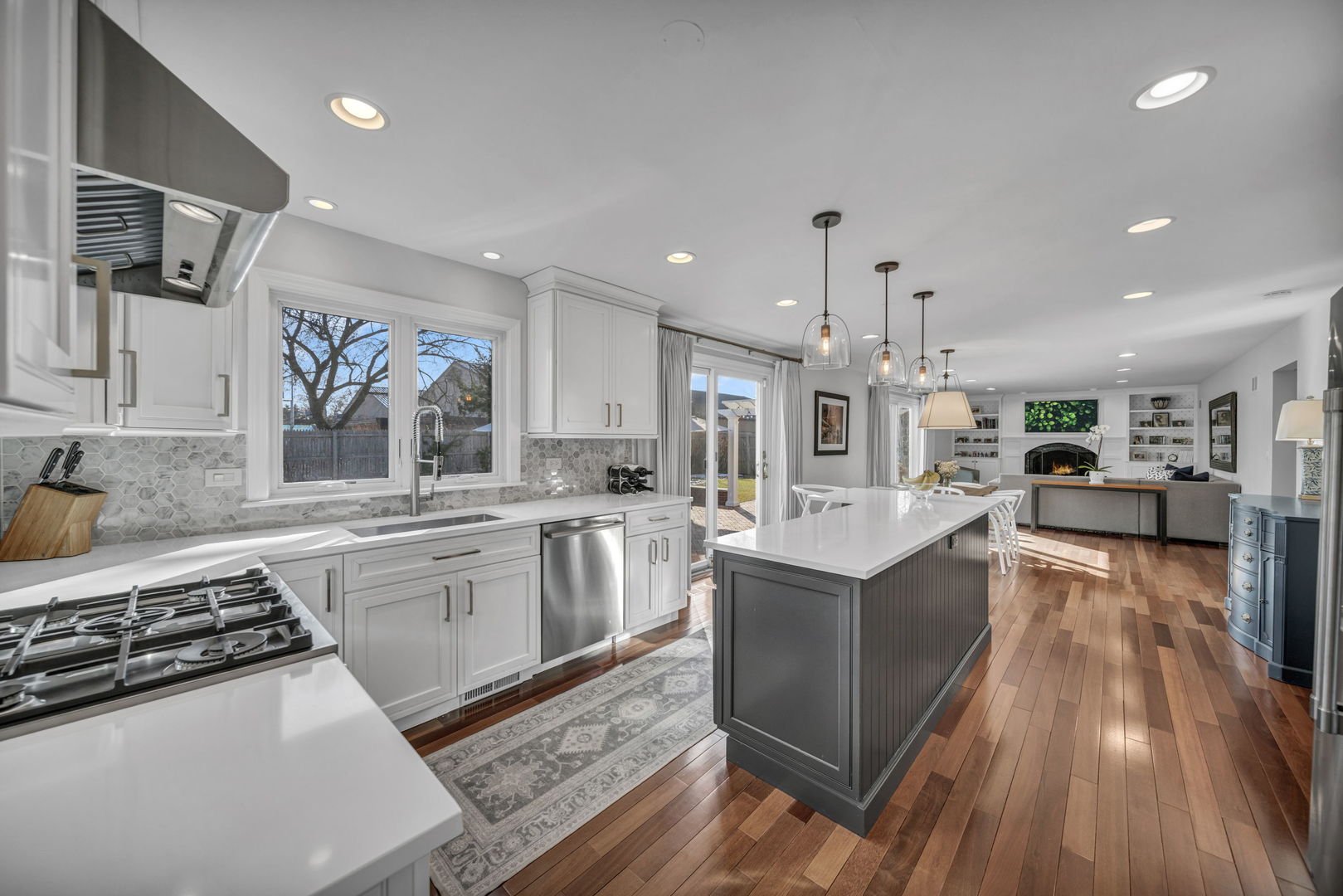1810 Wagner Road Glenview, IL 60025 - Photo 8 of 32 a kitchen with stainless steel appliances granite countertop a stove top oven a sink dishwasher and a refrigerator with wooden floor