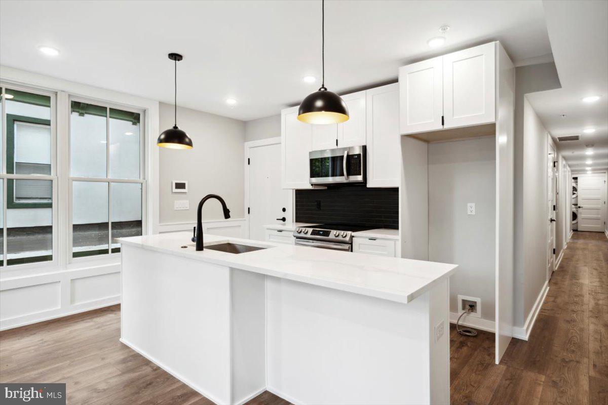 3519 Hamilton Street, Unit A Philadelphia, PA 19104 - Photo 29 of 47 a kitchen with kitchen island a sink stainless steel appliances and cabinets