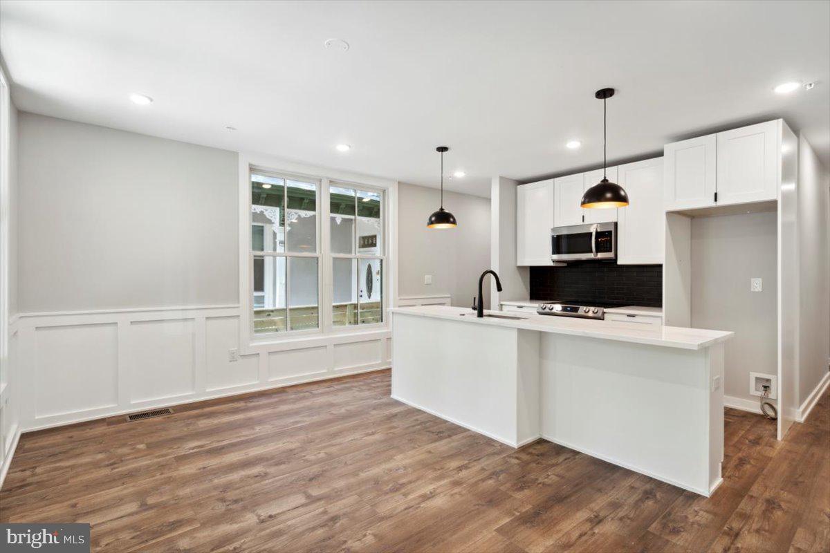 3519 Hamilton Street, Unit A Philadelphia, PA 19104 - Photo 3 of 47 a kitchen with stainless steel appliances a stove top oven a sink and a refrigerator