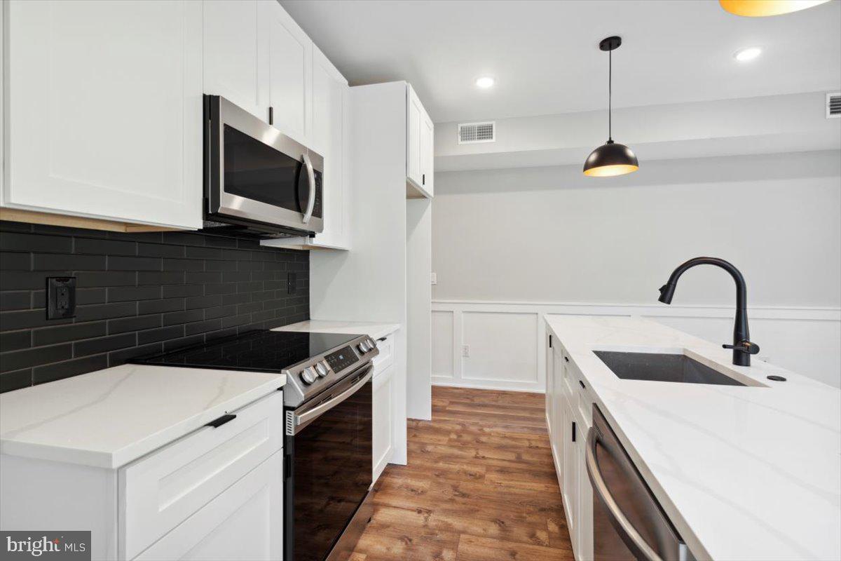 3519 Hamilton Street, Unit A Philadelphia, PA 19104 - Photo 40 of 47 a kitchen with a sink and stainless steel appliances