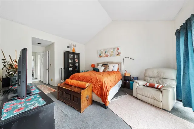 a bedroom with a bed and a couch