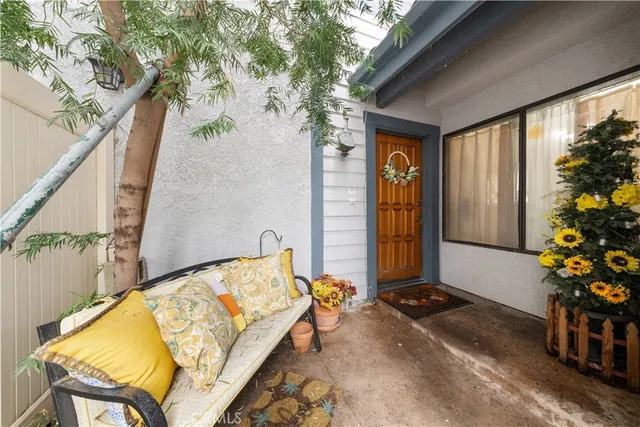 a view of patio with a table and chairs and potted plants