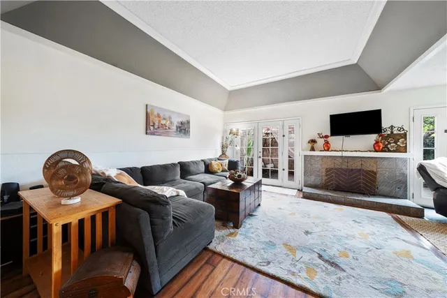 a living room with furniture a flat screen tv and dresser