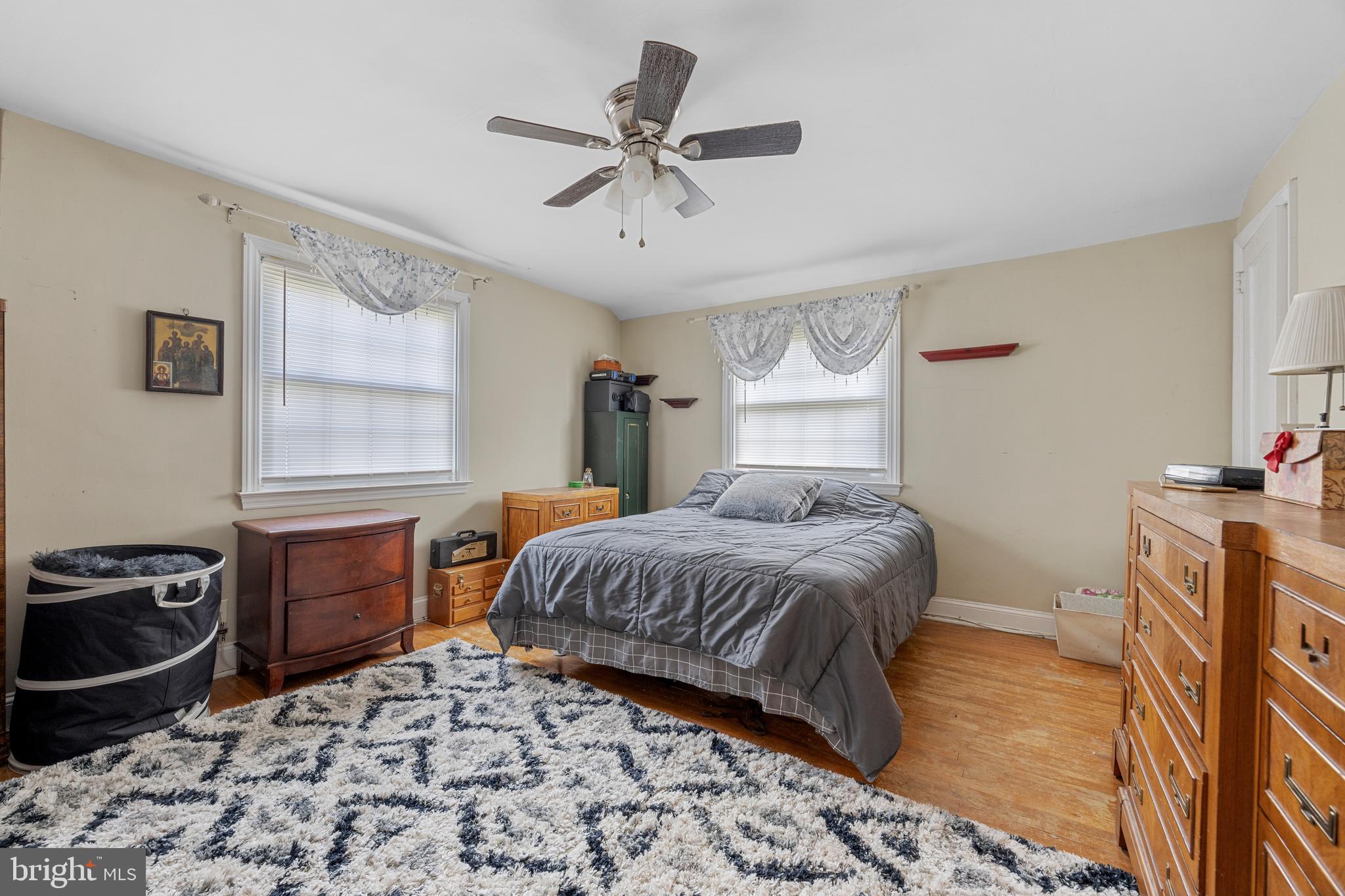 511 Rodney Lane Springfield, PA 19064 - Photo 13 of 23 a bedroom with a bed and a dresser with wooden floor