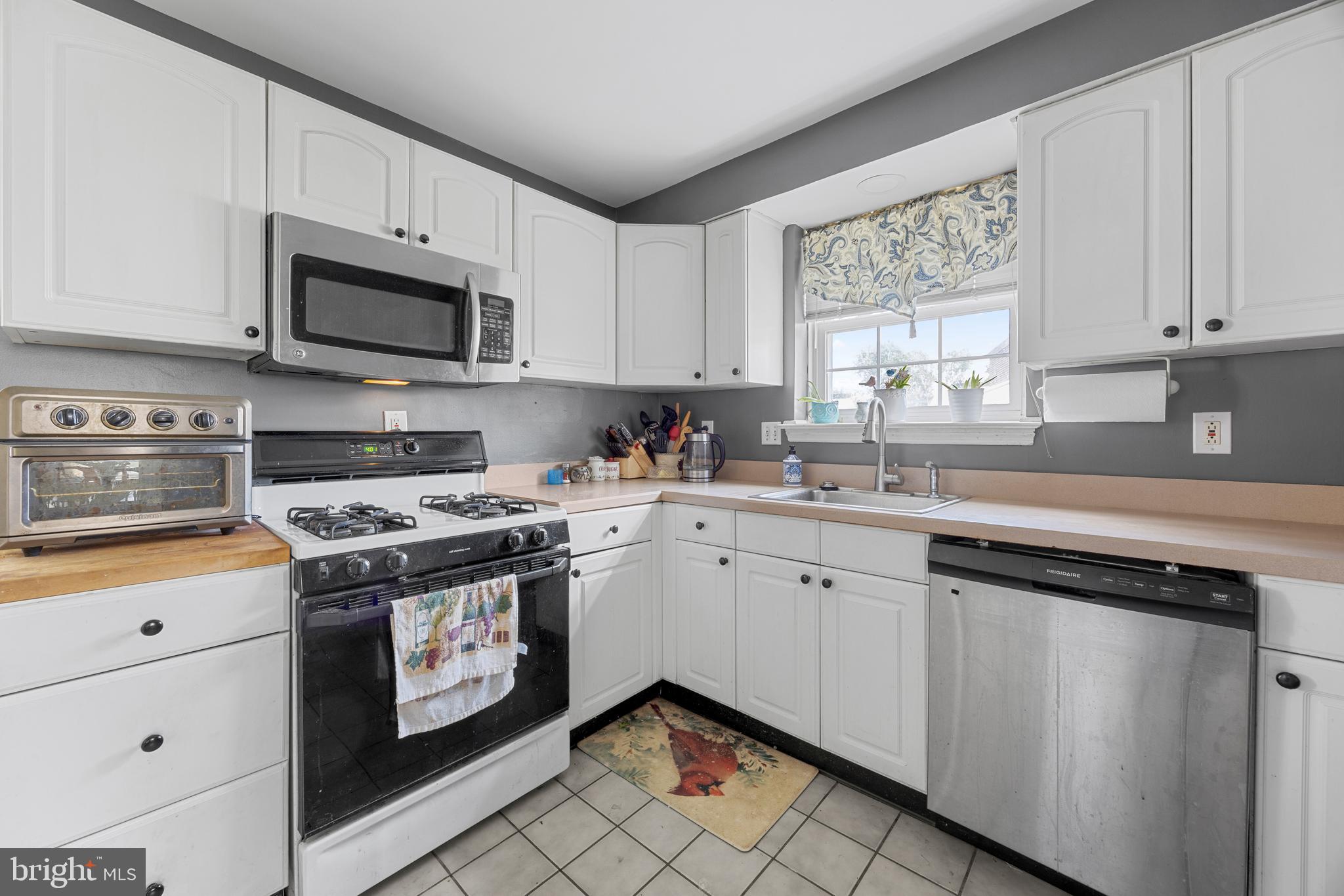 511 Rodney Lane Springfield, PA 19064 - Photo 10 of 23 a kitchen with cabinets appliances a sink and a window