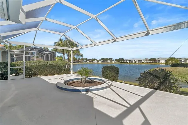 a view of a patio with a table and chairs under an umbrella