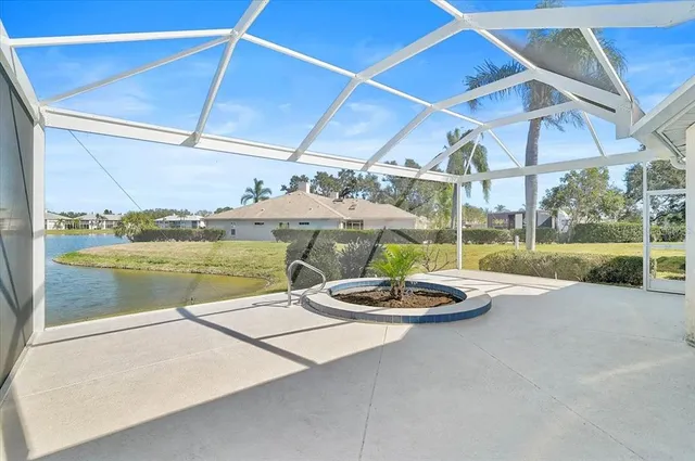 a view of a patio with a table and chairs under an umbrella